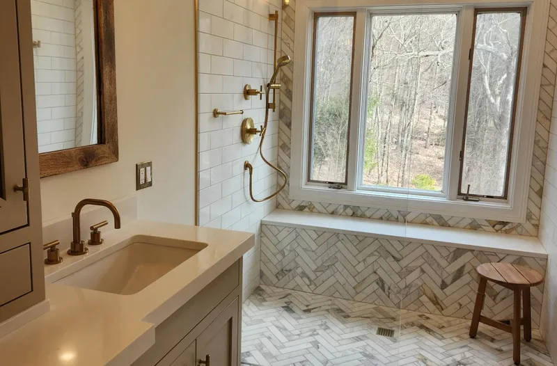 Bathroom remodel in Canton, CT with herringbone marble and a curbless shower