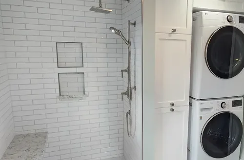 Curbless shower beside a stacked laundry in Bristol, CT