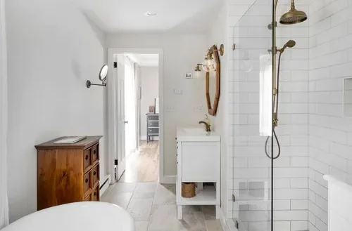 Bathroom with a soaking tub and brass shower in Southington, CT